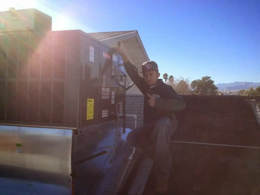HVAC technician performing HVAC Inspection on a rooftop unit in Murrells Inlet